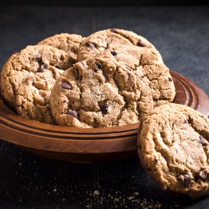 Homemade chocolate chip cookies in the wooden plate,selective focus